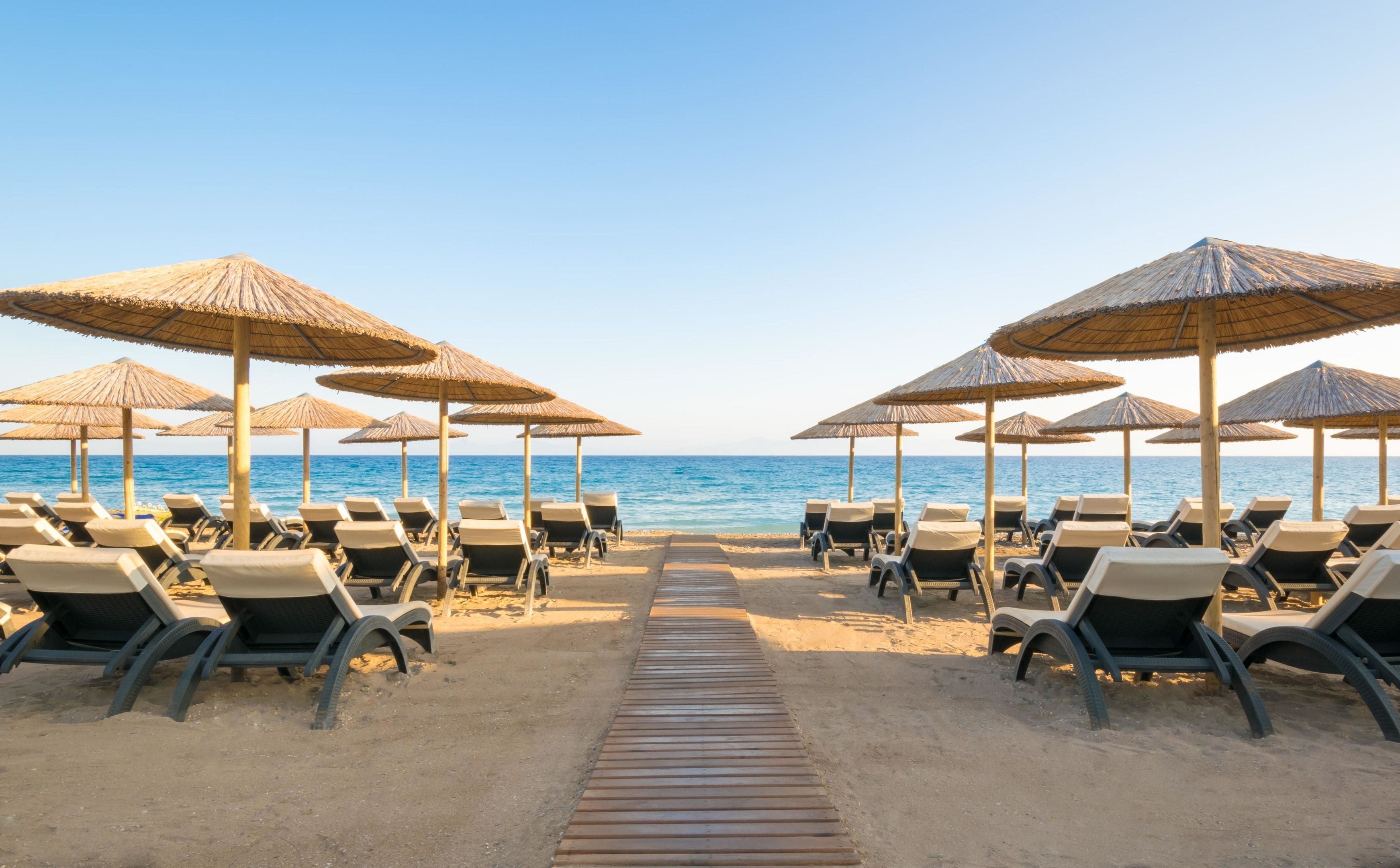 On the beach, sun-loungers, beach umbrellas, beach towels