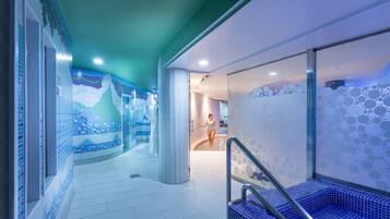 Swimmers can enjoy a refreshing dip in the pool surrounded by a mosaic tile design.