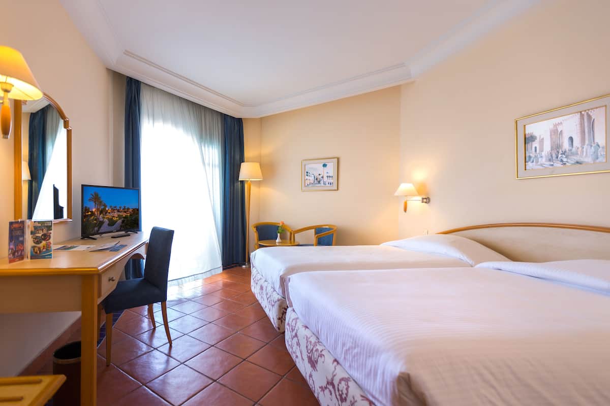 family triple room | 1 bedroom, minibar, in-room safe, blackout curtains