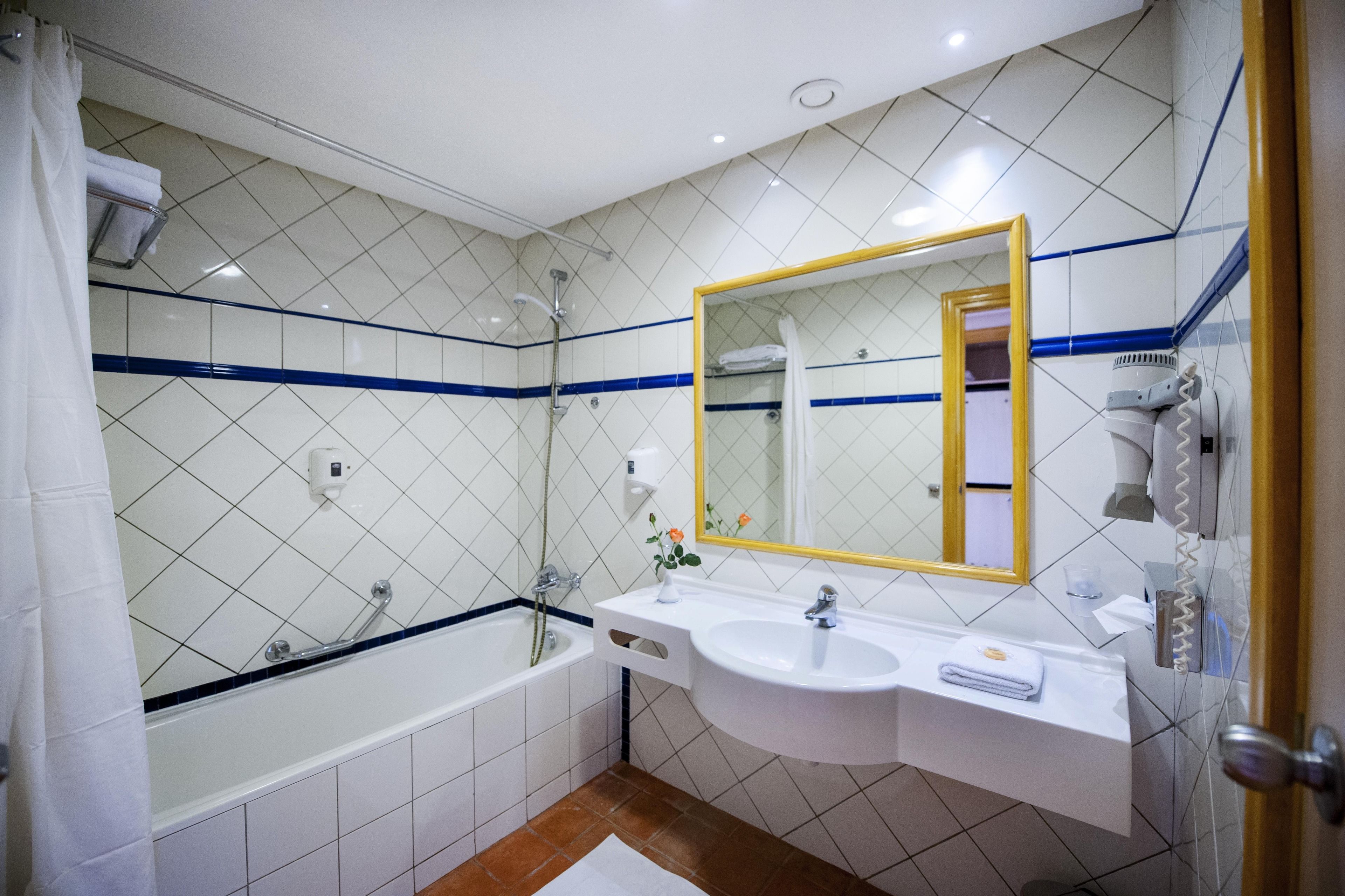 bathtub, free toiletries, hair dryer, towels