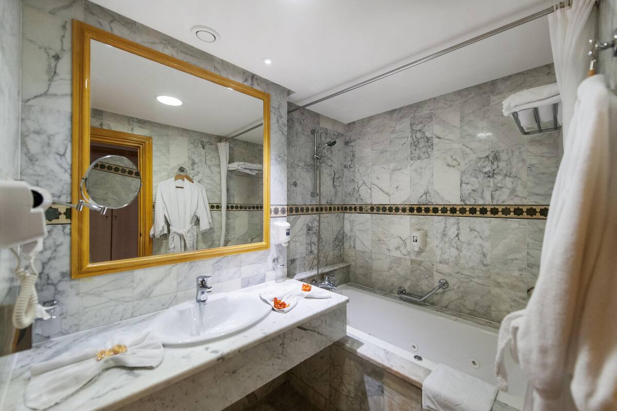 bathtub, free toiletries, hair dryer, towels