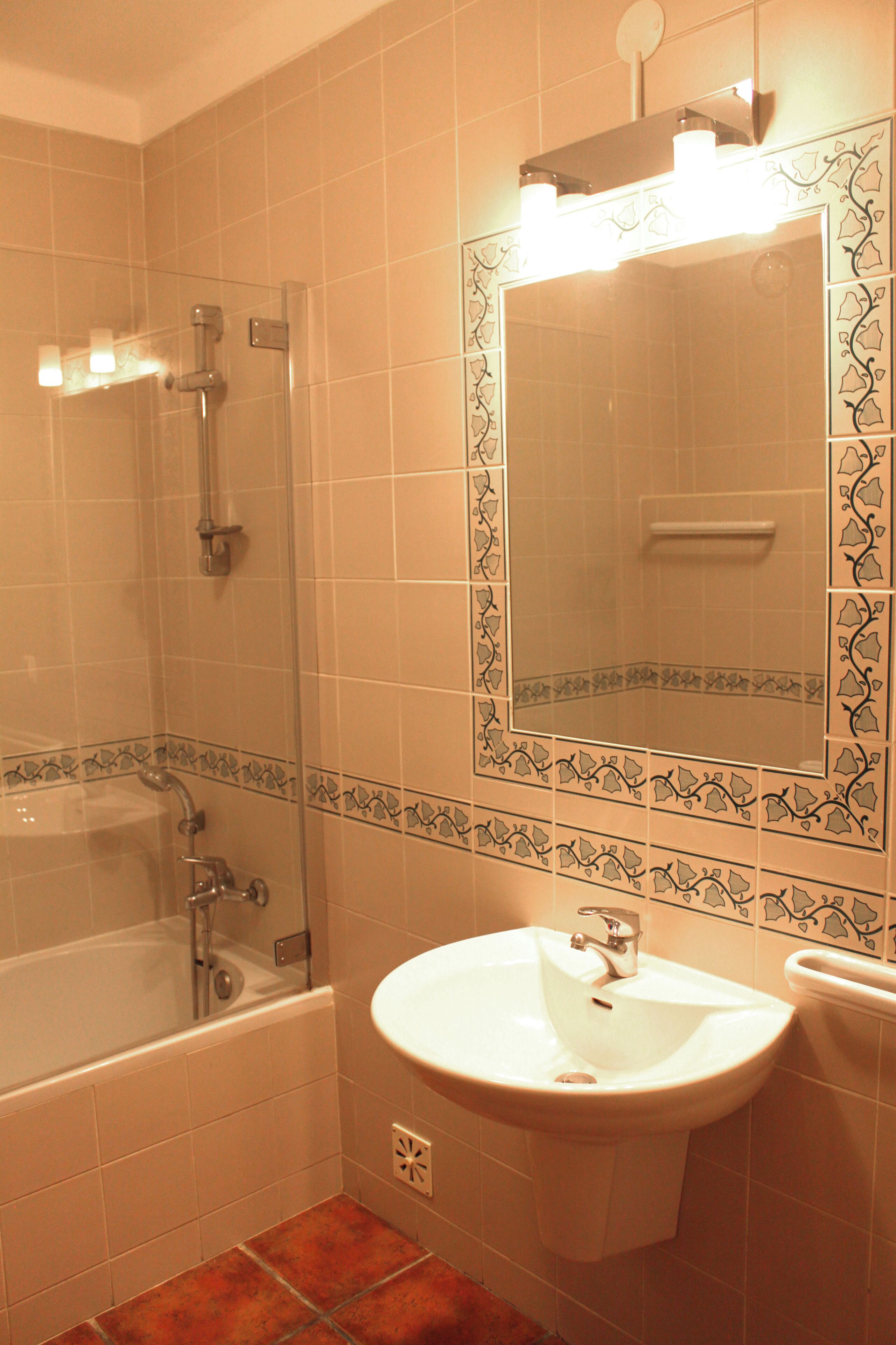 A bathroom with a bathtub, a sink, and a shower.
