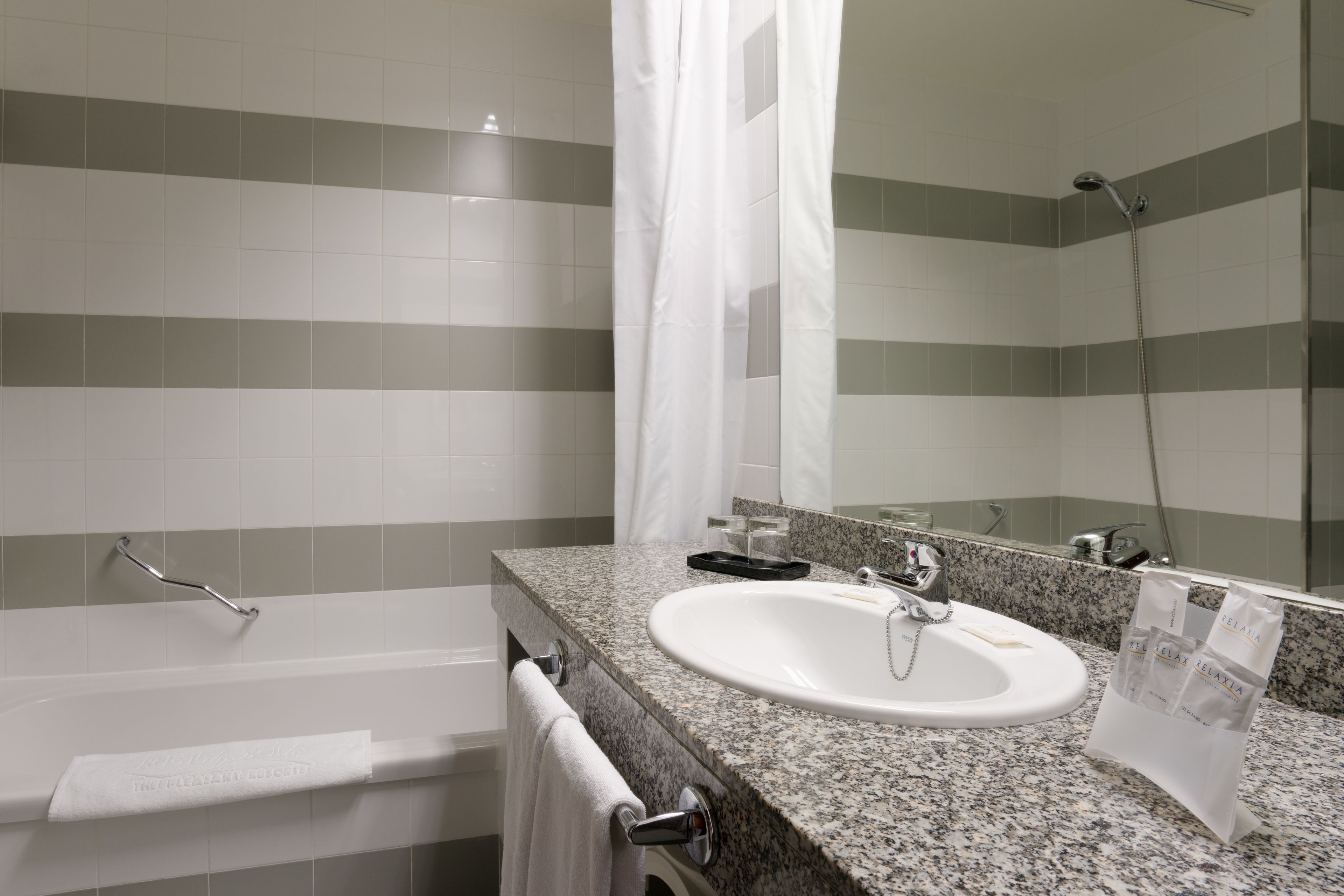 bathtub, hair dryer, bidet, towels