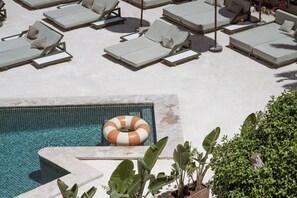 A pool area with multiple sun loungers and a lifebuoy. - Hotel Galfi - Boutique & Adults Only (Sant Antoni de Portmany)