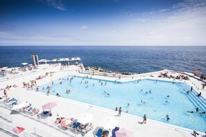 A large pool area on a cruise ship with multiple swimming areas and sun loungers. - Terrace Mar (Funchal)