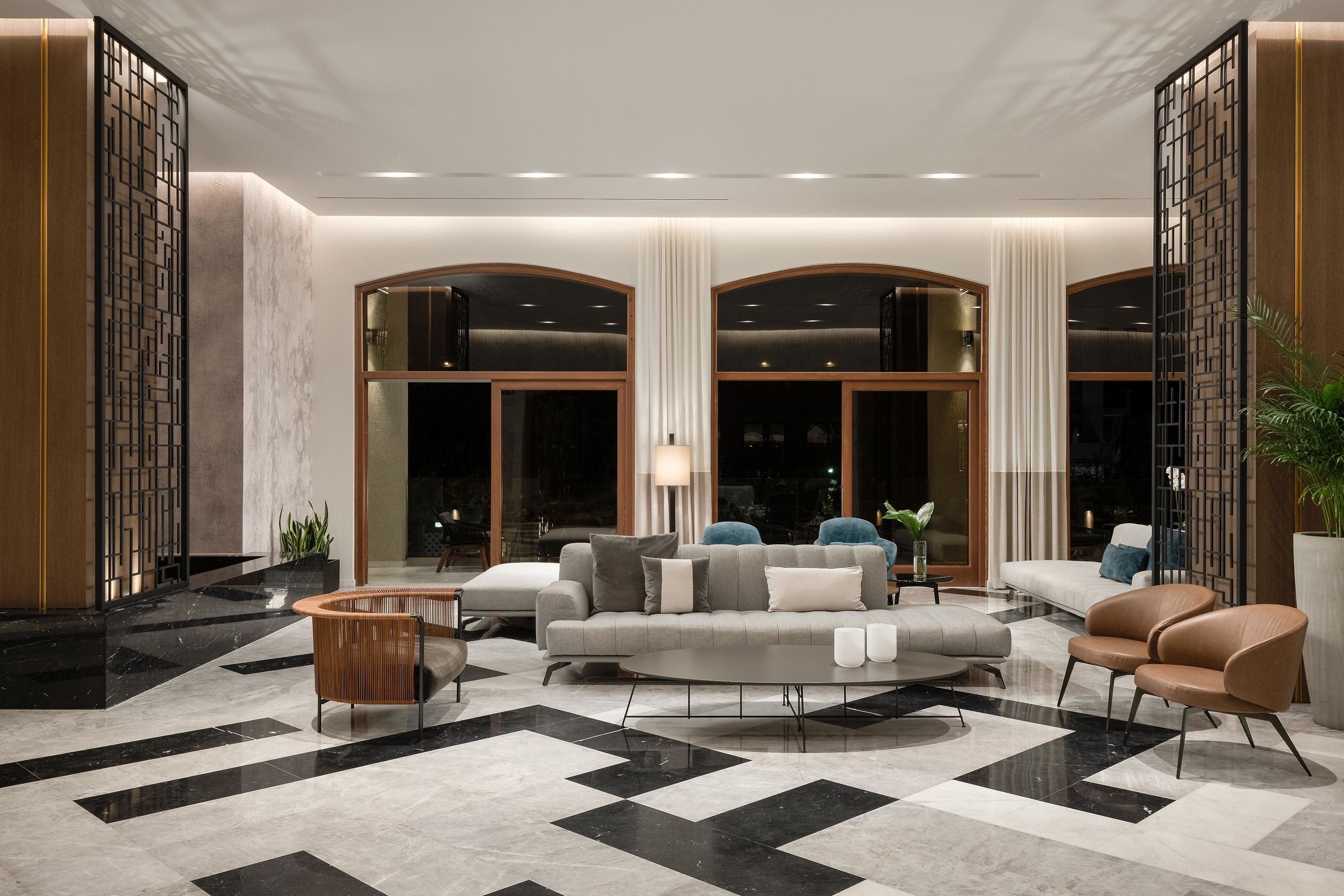 A spacious lobby with a checkered floor, a sofa set, and a coffee table.