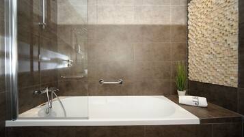 A modern bathroom with a glass-enclosed bathtub, a wall-mounted sink, and a decorative mosaic wall.