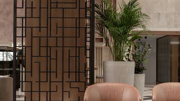 A modern interior with a sectional sofa, a round coffee table, and a decorative wooden partition.
