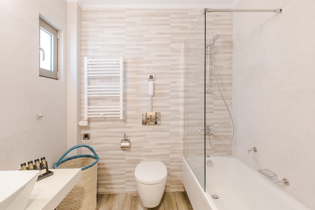 deluxe suite, 1 queen bed with sofa bed | bathroom | rainfall showerhead, free toiletries, hair dryer, towels