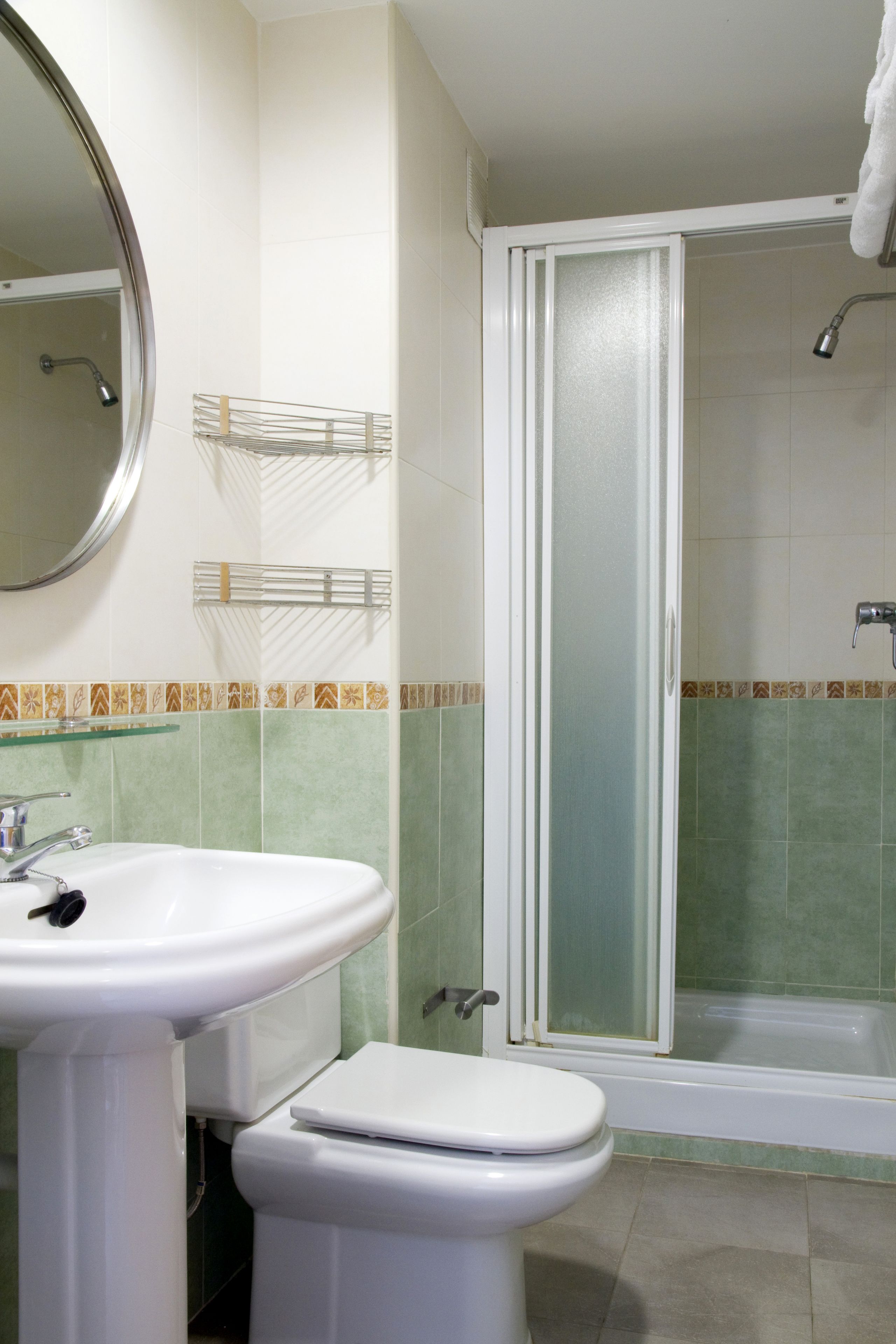 A bathroom with a sink, toilet, and shower.