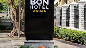 A black sign with "BON HOTEL ABUJA" and a crown symbol. - BON Hotel Abuja (Abuja)