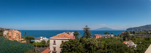 Experience the serene coastal town with breathtaking views of the sea and distant mountains.