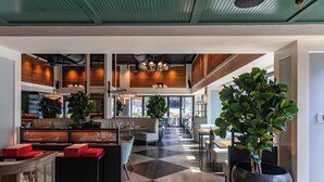A spacious lobby with a checkered floor, seating areas, and large potted plants. - Hutton Hotel, Nashville, a Tribute Portfolio Hotel (Nashville)