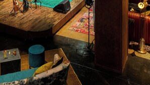 A stage with musical instruments, a drum set, and a guitar. - Hutton Hotel, Nashville, a Tribute Portfolio Hotel (Nashville)