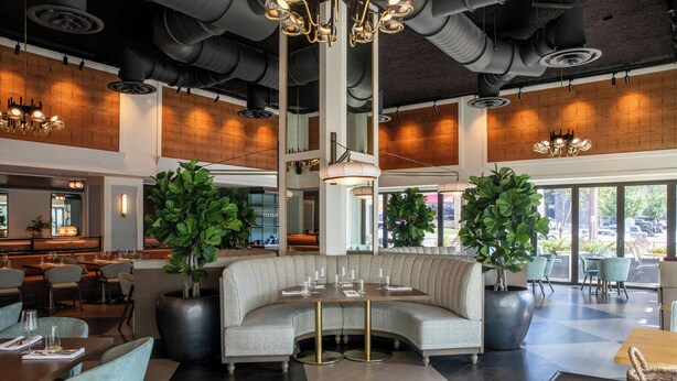 A modern interior with a central seating area, large windows, and a bar. - Hutton Hotel, Nashville, a Tribute Portfolio Hotel (Nashville)