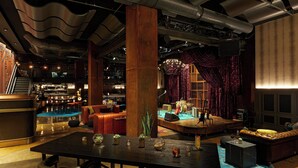 A bar area with a stage, seating, and a pool table. - Hutton Hotel, Nashville, a Tribute Portfolio Hotel (Nashville)