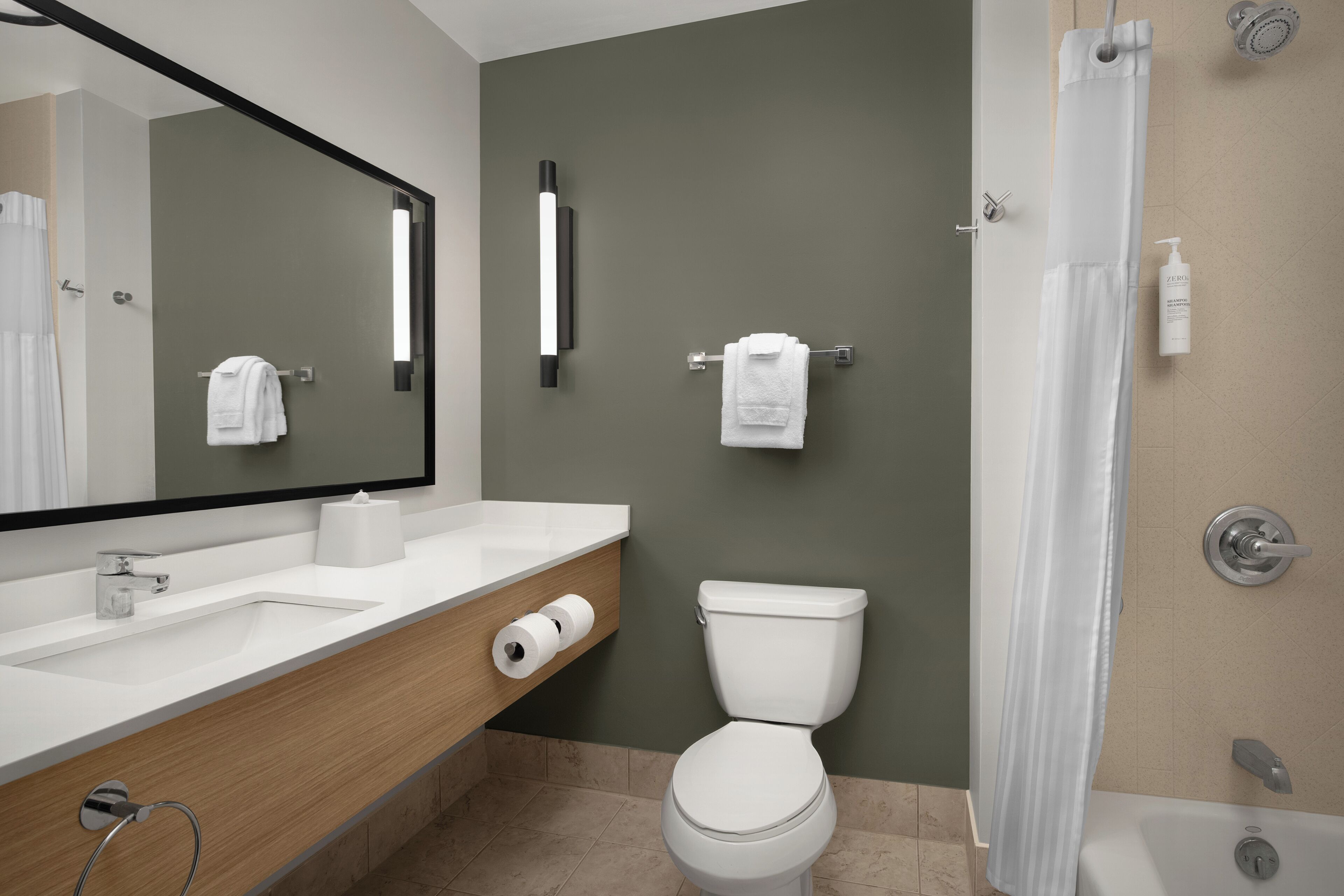 Un baño moderno con lavabo, inodoro y ducha.