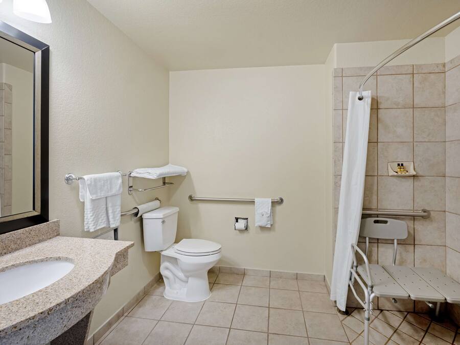 A bathroom with a sink, toilet, and shower.