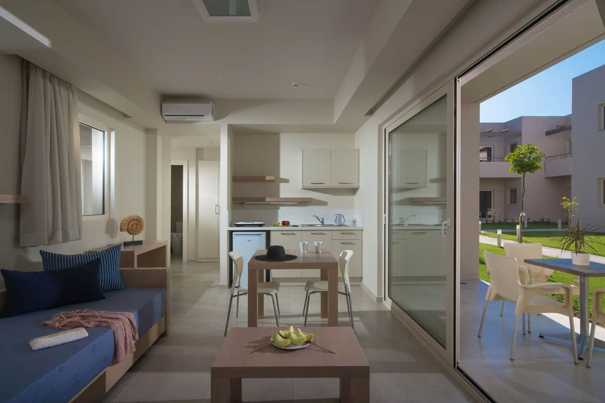 A modern apartment with a living area, dining space, and a kitchen.