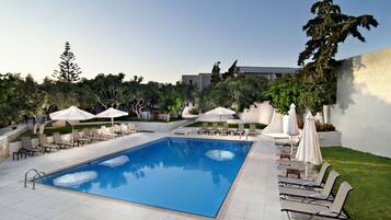 Seasonal outdoor pool, open 9:00 AM to 8 PM, pool umbrellas