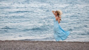 A woman in a blue dress standing by the sea. - City Life Port Hotel (Heraklion)