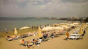 On the beach, sun loungers, beach umbrellas, beach towels