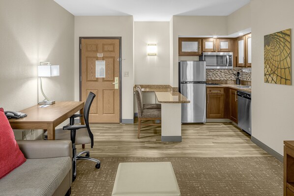 A compact hotel room with a kitchenette, a dining area, and a seating area. - Staybridge Suites Chattanooga at Hamilton Place by IHG (Chattanooga)