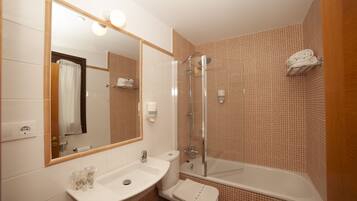 Un baño con lavamanos, inodoro y ducha.