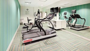 A fitness center with treadmills, a desk, and a television. - Holiday Inn Express & Suites Clovis-Fresno Area by IHG (Clovis)