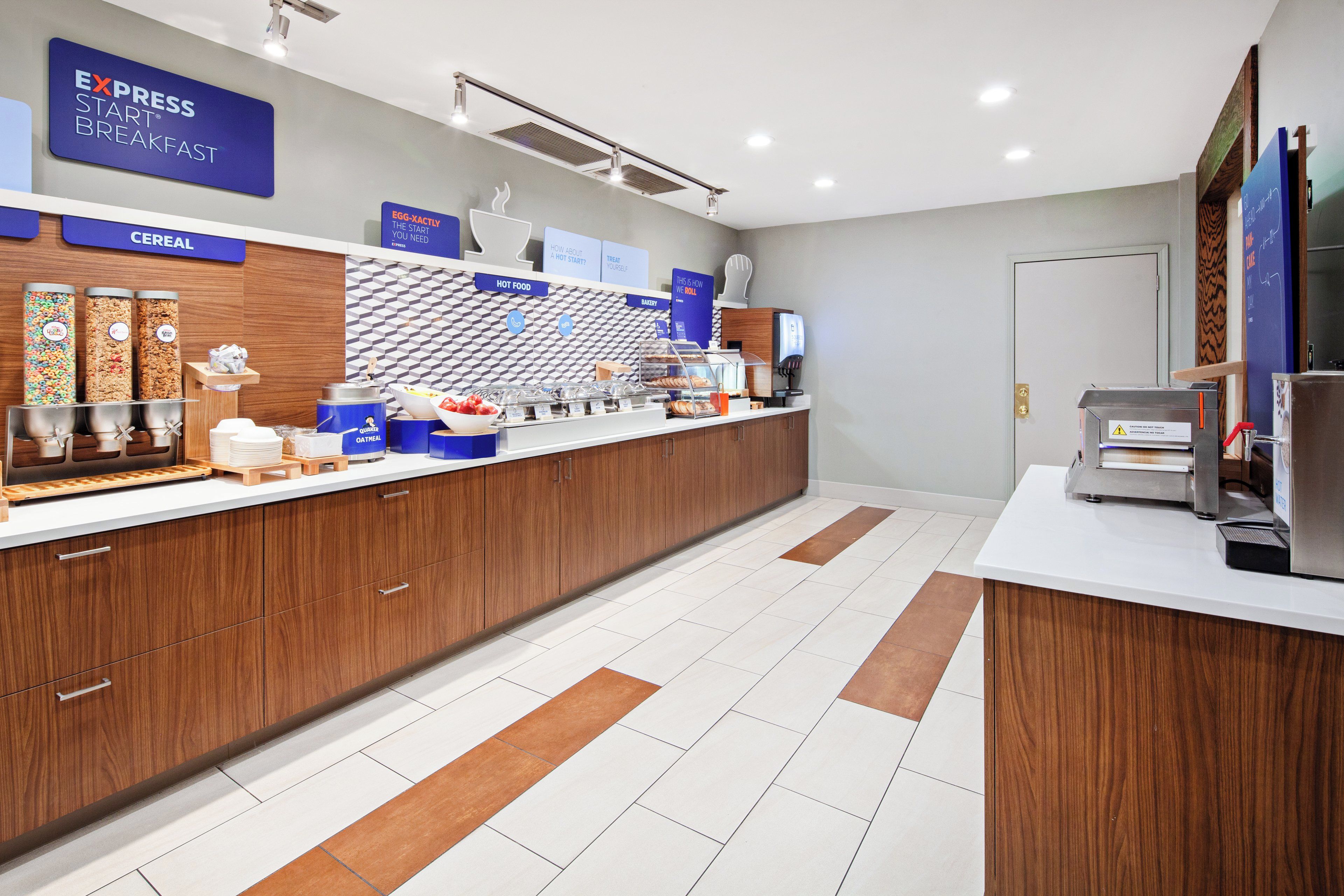 A breakfast area with a sign for 'EXPRESS START BREAKFAST', cereal dispensers, an 'EGG-XACTLY' station, and a 'HOT FOOD' section.