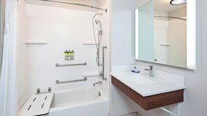 A modern bathroom with a bathtub, shower, vanity, and mirror. - Holiday Inn Express & Suites Clovis-Fresno Area by IHG (Clovis)
