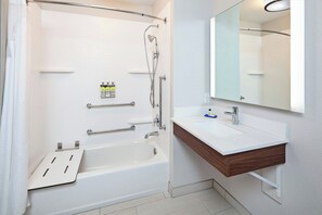 A modern bathroom with a bathtub, shower, vanity, and mirror. - Holiday Inn Express & Suites Clovis-Fresno Area by IHG (Clovis)