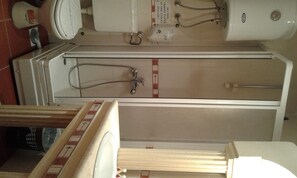 A bathroom with a bathtub, a toilet, and a shower. There is a sign on the wall that says "DO NOT THROW PAPER IN THE TOILET PLEASE". - Ani Hotel (Skopje)