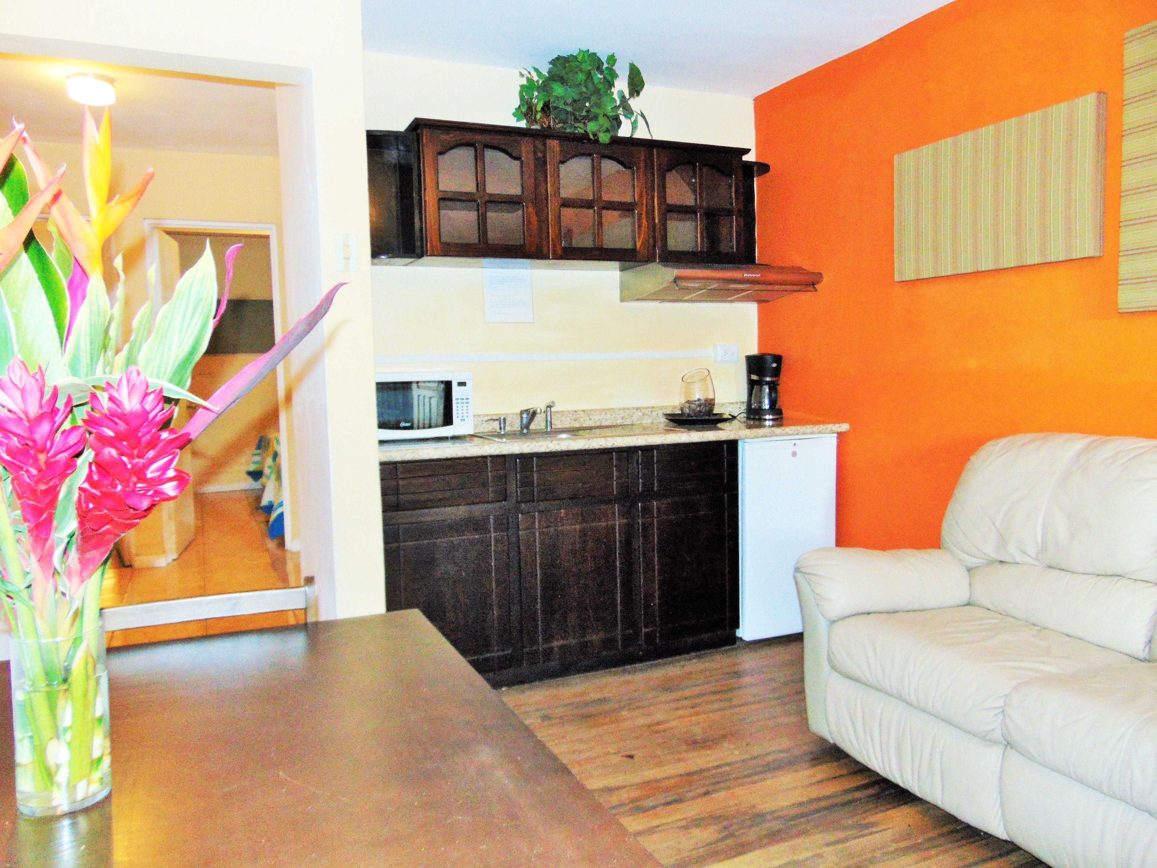 A compact living space with a kitchenette, a dining area, and a seating area.
