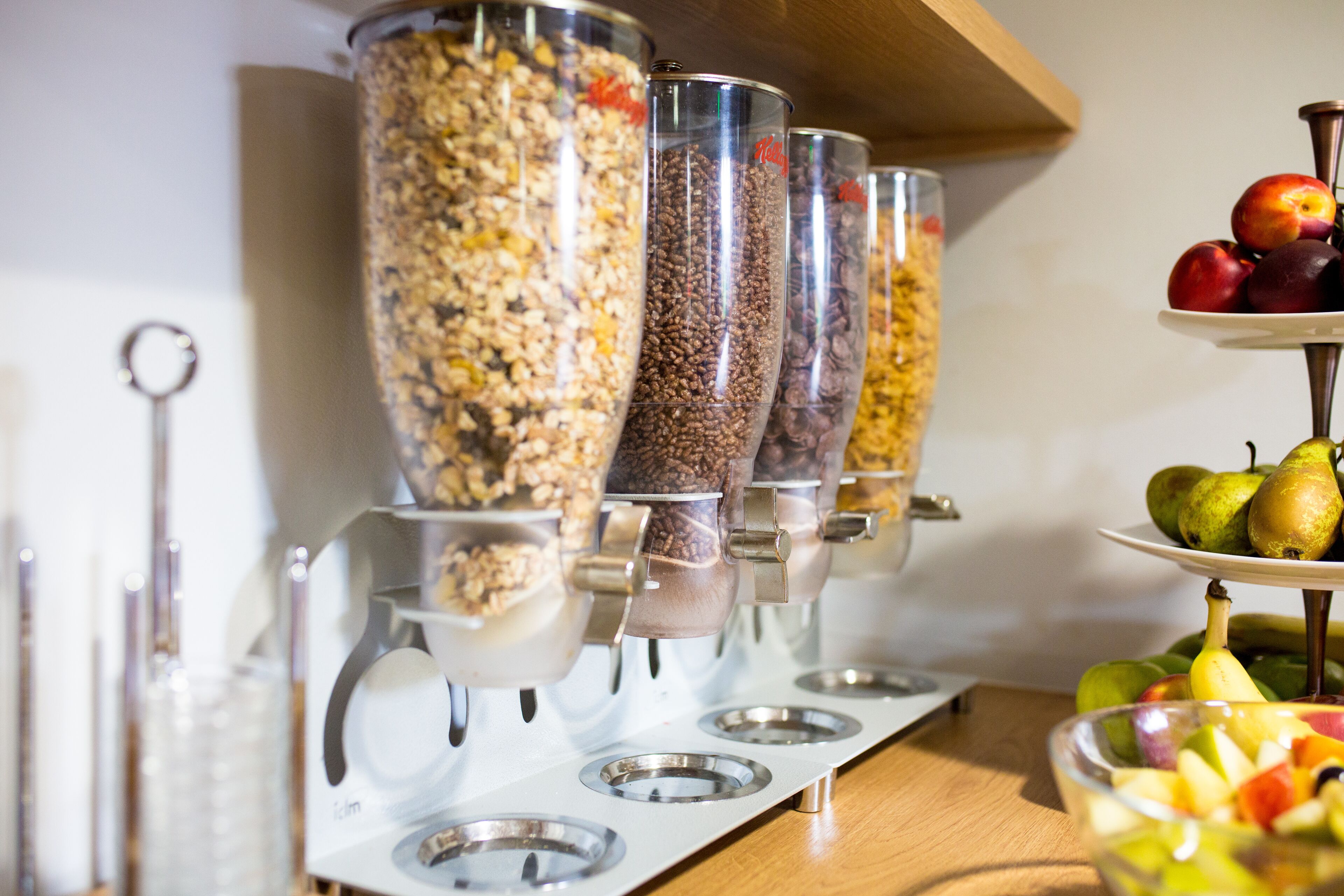 A food dispensing station with multiple containers for different food items.