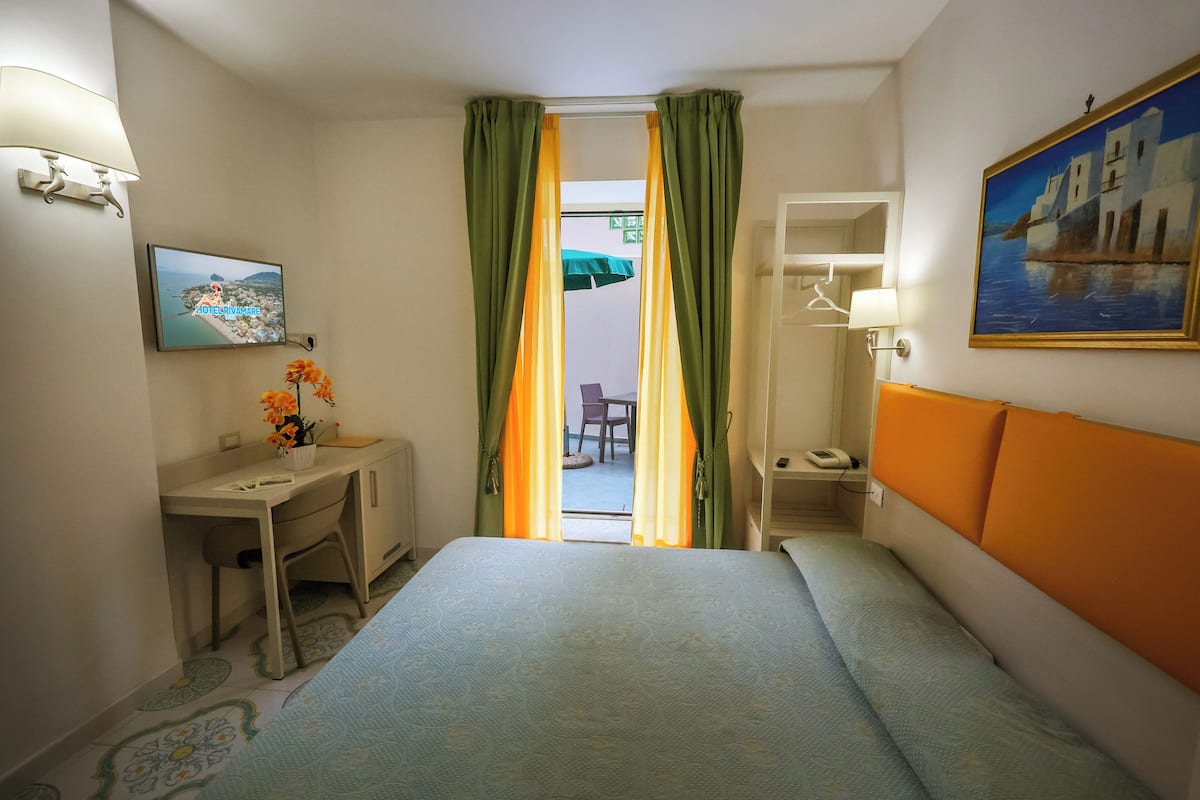 Double Room, Patio (Parterre) | Minibar, in-room safe, desk, laptop workspace