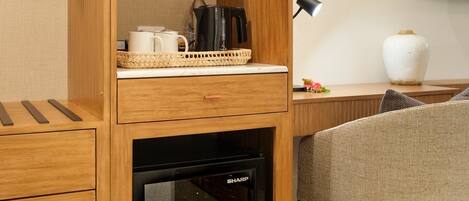 A compact kitchenette with a microwave, a small oven, and a coffee maker.