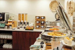 A buffet with various food items and a coffee station. - Fiji Gateway Hotel (Nadi)