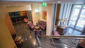 A hotel lobby with a staircase, seating area, and a bar. - Hotel de Cerva (Ribeira de Pena)