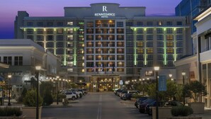 A multi-story hotel with a prominent 'Renaissance Hotel' sign, a parking lot, and a street view with other buildings. - Renaissance Raleigh North Hills Hotel (Raleigh)