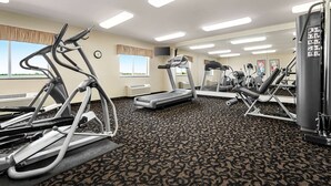 A gym with treadmills, elliptical machines, and weight equipment.