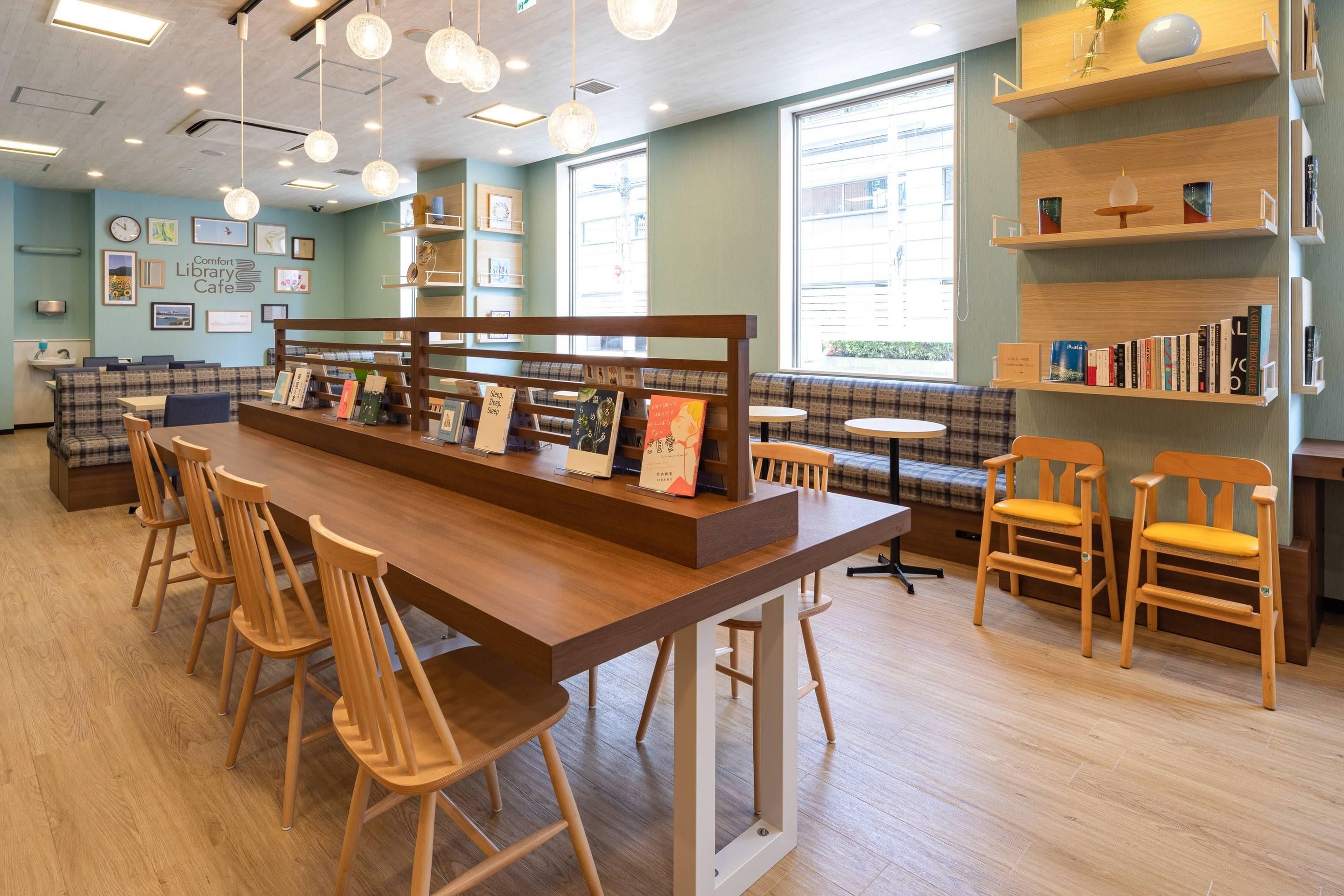 A cozy library cafe with wooden furniture, bookshelves, and a seating area.