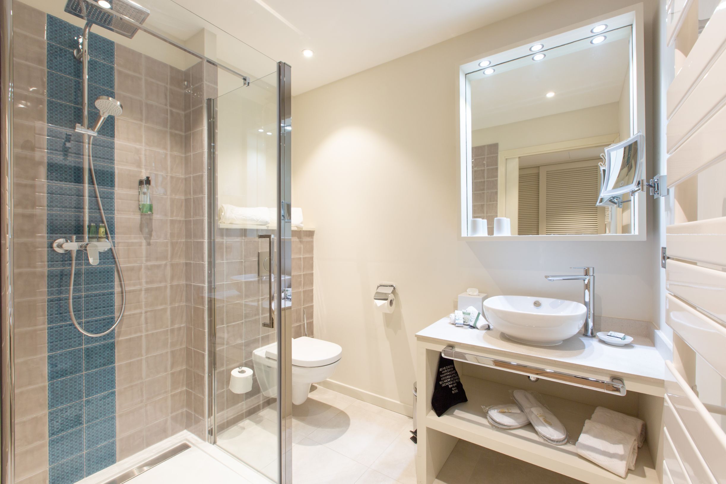 designer toiletries, hair dryer, bathrobes, slippers