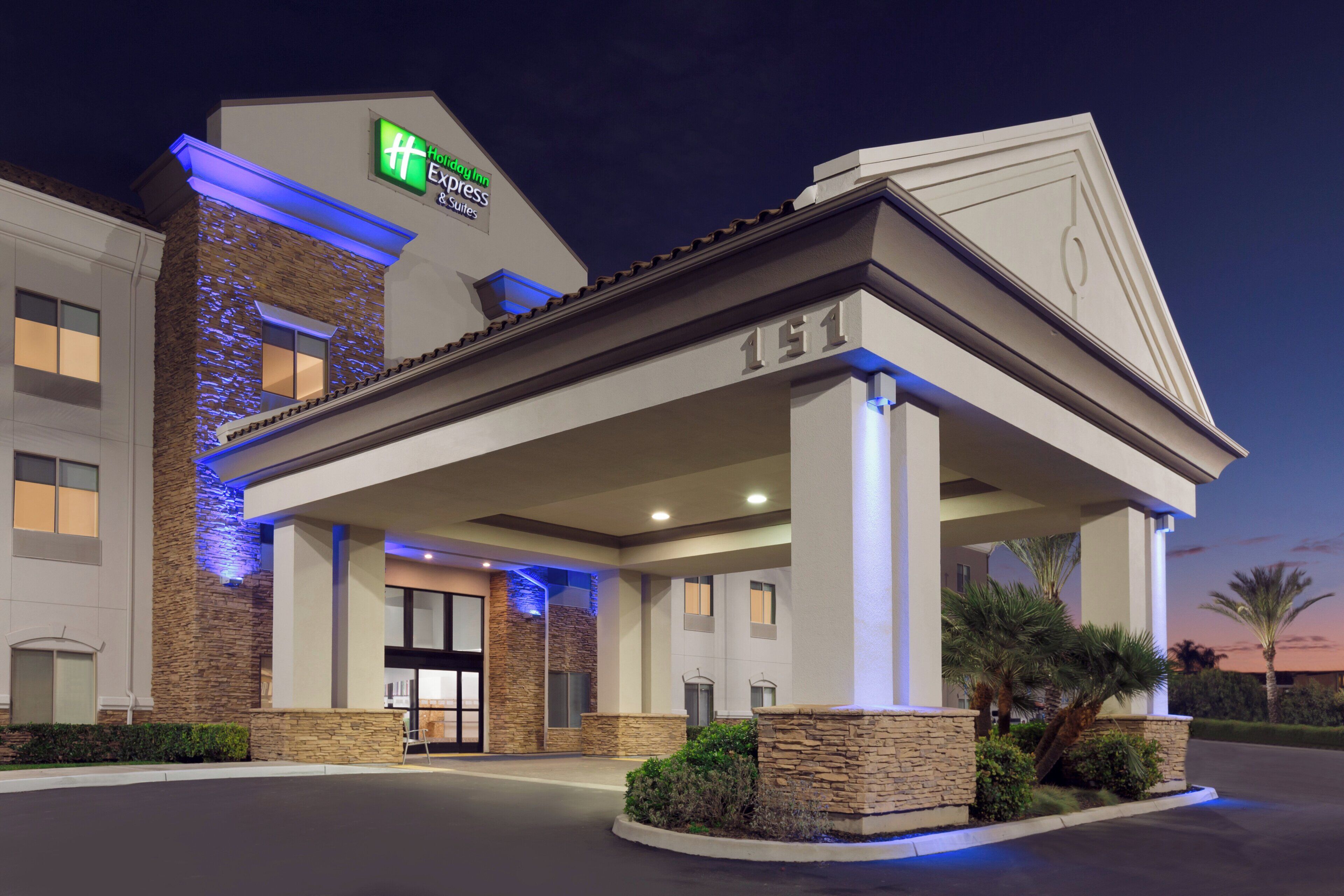 A hotel with a modern facade, stone accents, and a prominent entrance.