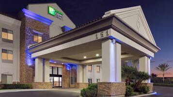 A hotel with a modern facade, stone accents, and a prominent entrance.