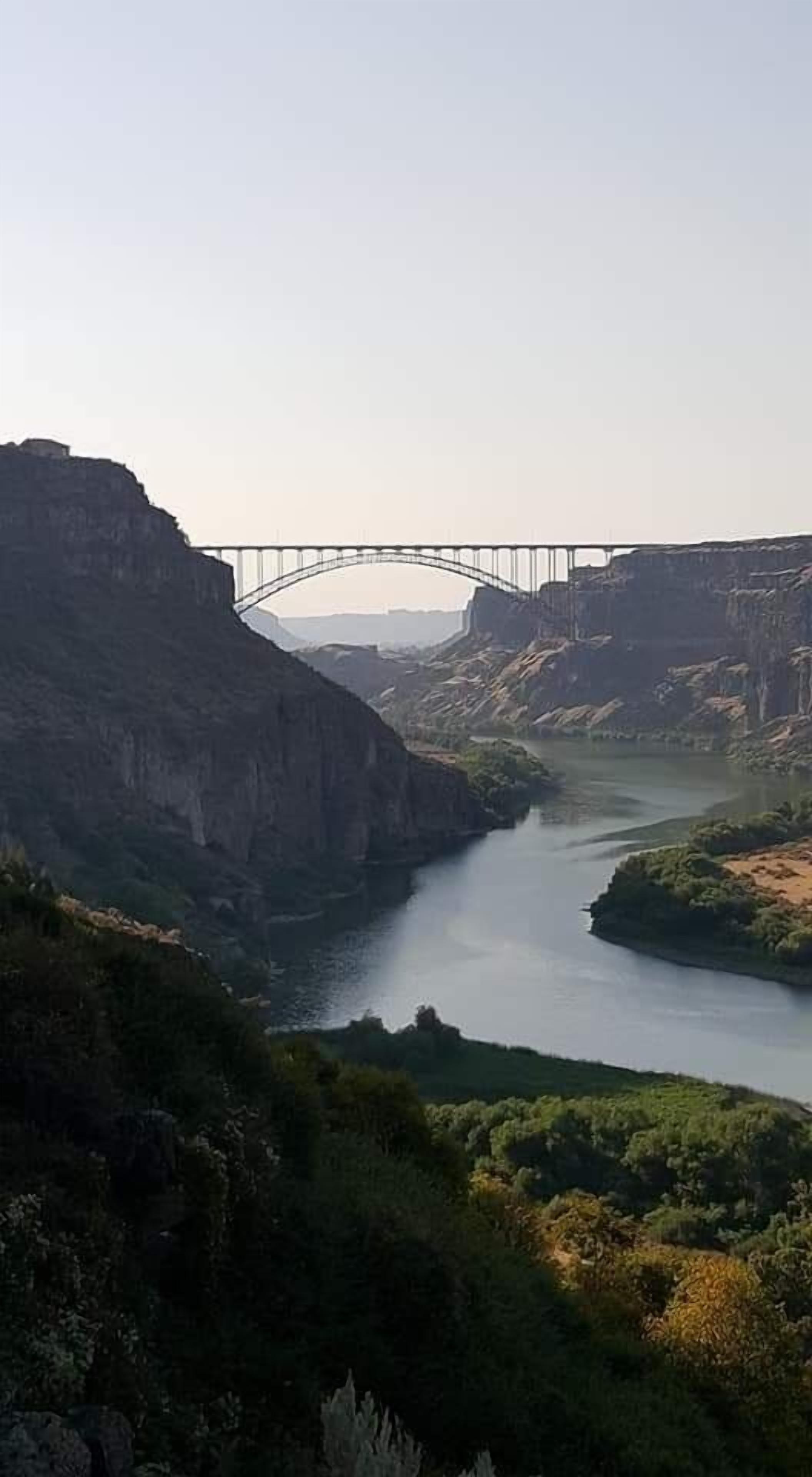 A river canyon with a bridge spanning across it.