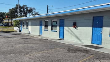 A single-story motel with a blue exterior and white walls.