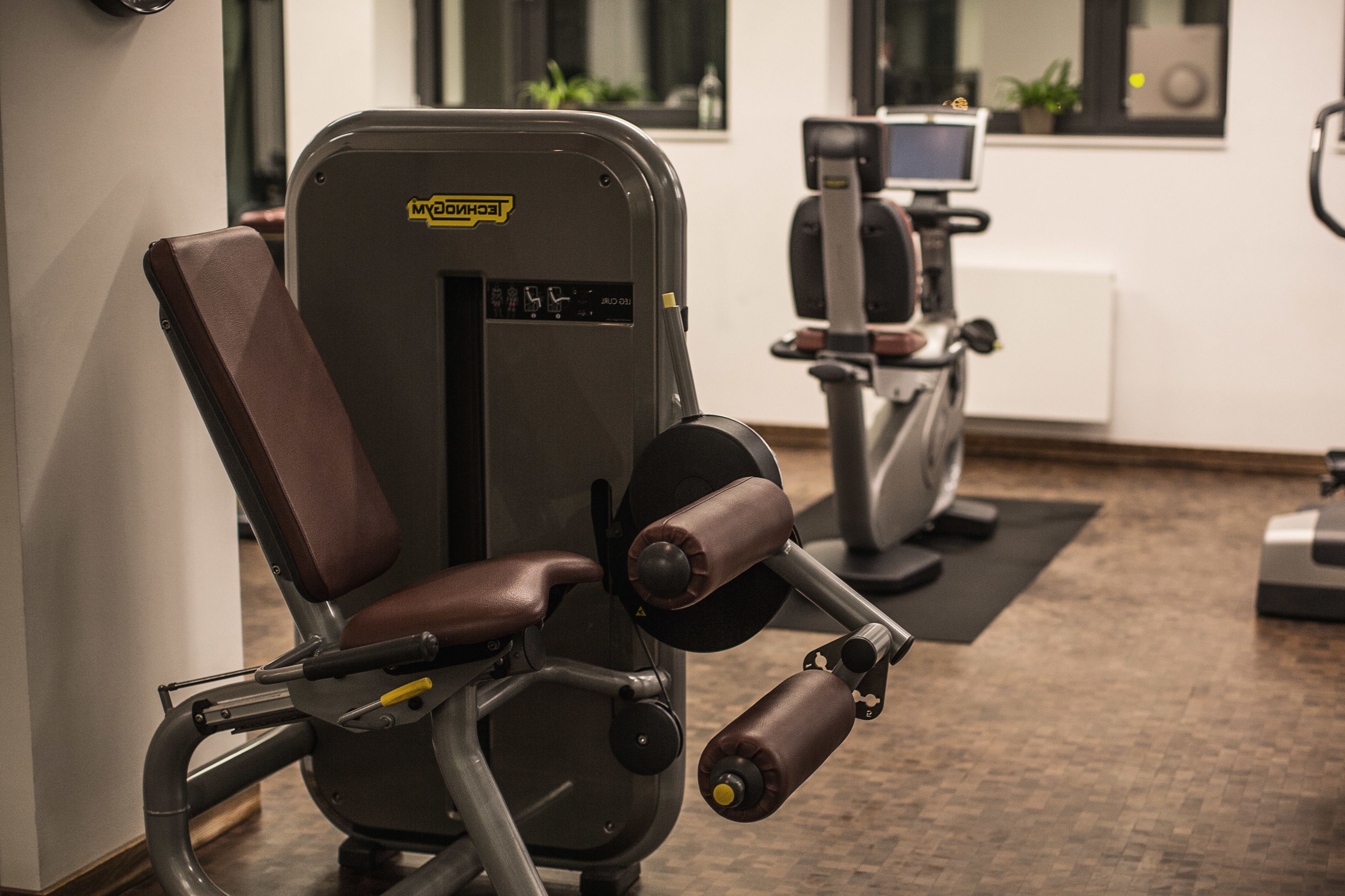 A gym with exercise equipment, including a weight machine and a stationary bike.