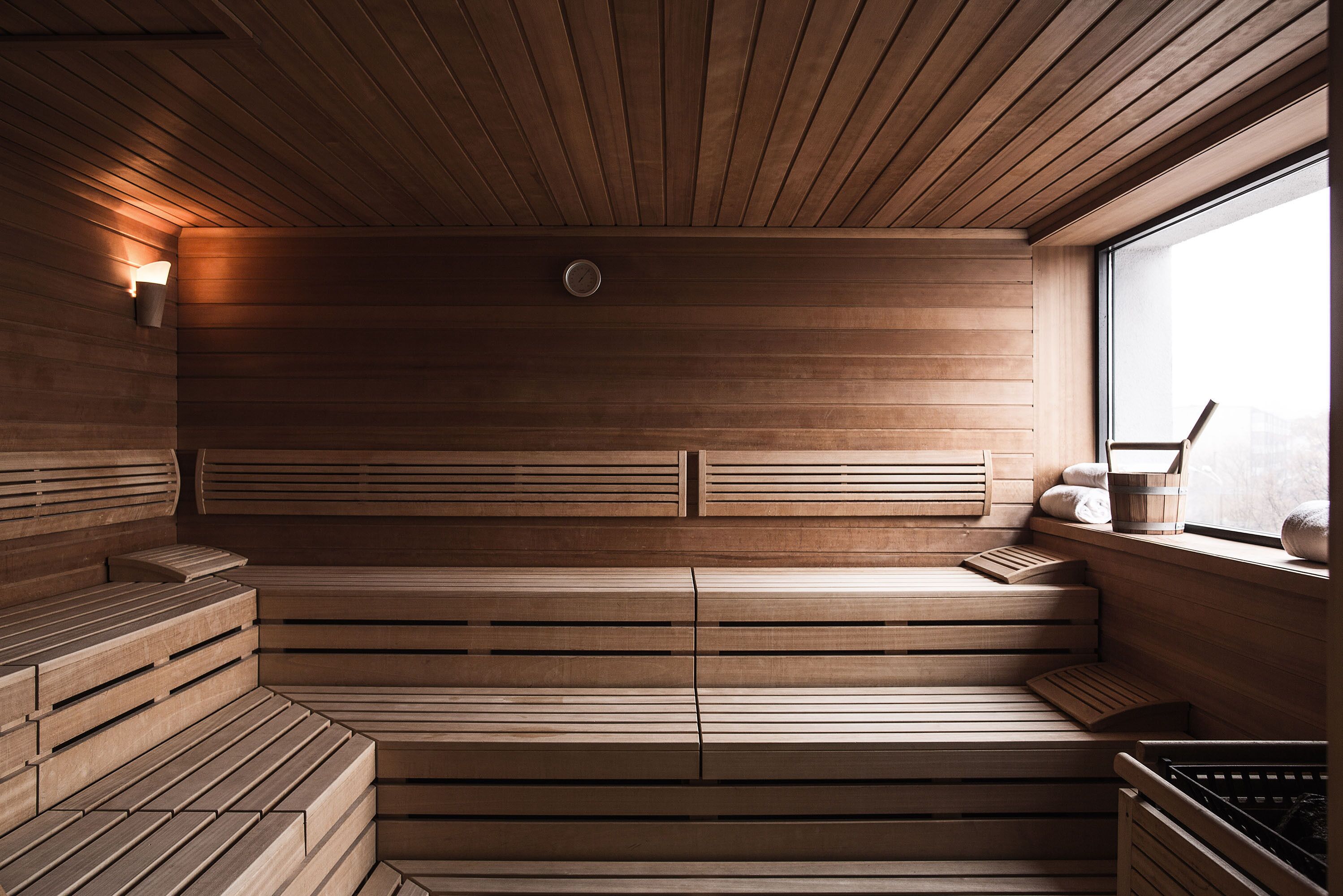 A sauna with wooden benches and a window.