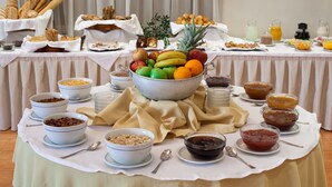 A buffet table with various food items and beverages. - Achillion Palace Hotel Rethymno City Center (Rethymno)
